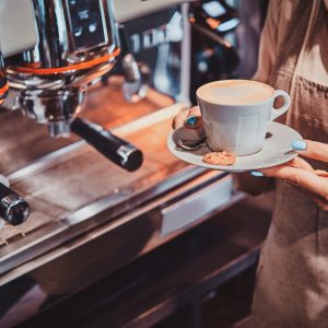 Process of coffee making using brand new coffee machine at cafe by expirienced barista.